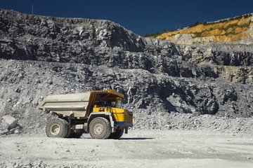 Heavy quarry truck in a limestone quarry, close-up.