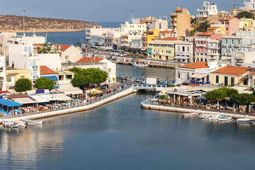 top view of a quiet bay and the Greek resort town of Agios Nikolaos on a sunny summer day