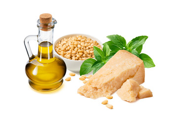 PPesto sauce ingredients, green basil leaves,  parmesan cheese, oil bottle and pine nuts in a cup isolated on white background