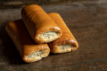 Delicious homemade sausage roll on a metal background. In the netherlands we call it a Worstenbroodje. Dutch snack.