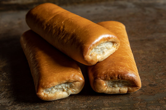 Delicious homemade sausage roll on a metal background. In the netherlands we call it a Worstenbroodje. Dutch snack.