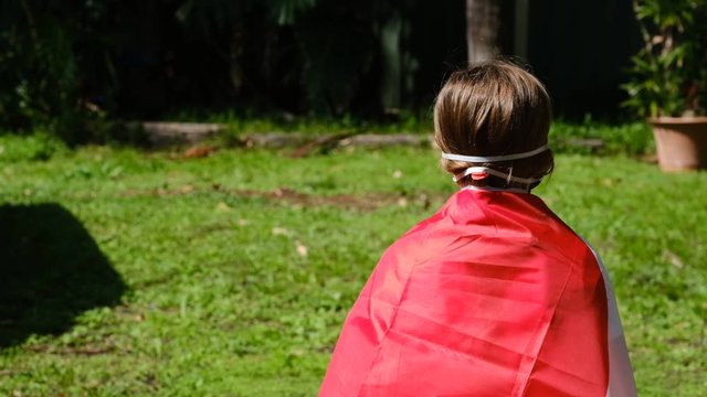 Small western girl wearing a Japanese flag taking precautions against coronavirus