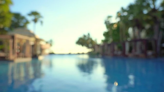 Blurred view of empty hotel swimming pool, seamless loop background