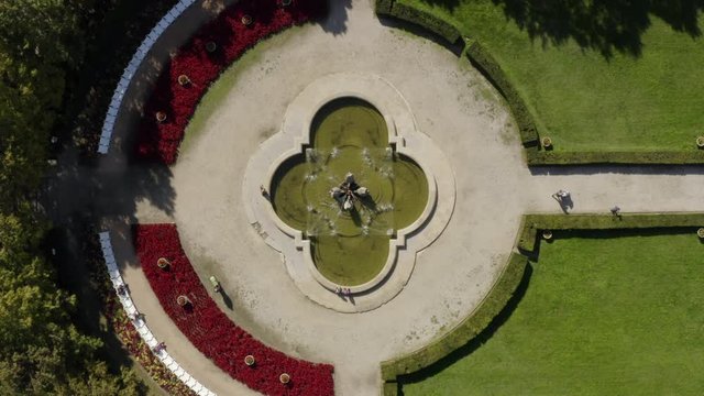Aerial drone shot in Bratislava, Medicka zahrada garden, zoomout from a fountain to a wide shot showing the whole garden.