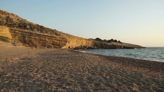 Layered, sedimentary rock on the sandy beach of Fourni Beach, Golden Hour, Rhodes Island, Greece