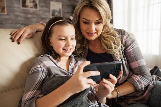 Modern Mother And Her Little Daughter With Braces