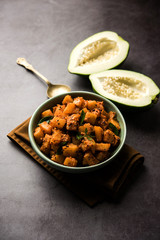 Kaccha Papita Sabji or Raw Papaya Sabzi, served in a karahi or bowl. selective focus