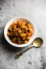 Kaccha Papita Sabji or Raw Papaya Sabzi, served in a karahi or bowl. selective focus