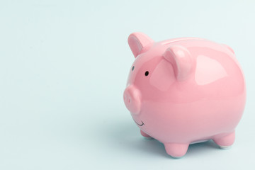 Piggy bank on blue background, space for text. Finance, saving money