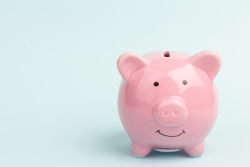 Piggy bank on blue background, space for text. Finance, saving money