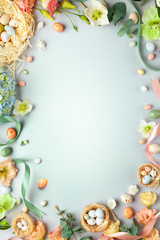 Happy Easter concept with easter eggs in nest and spring flowers. Easter background with copy...
