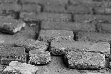 Black and white background with broken paving stones, soft focus