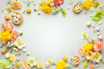 Happy Easter concept with easter eggs in nest and spring flowers. Easter background with copy...