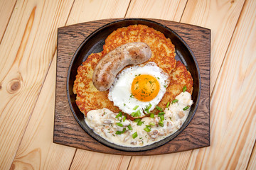 Fototapeta na wymiar potato pancake with egg and sausage