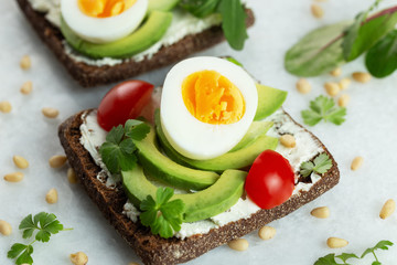  Sandwich with avocado, egg, tomato, cheese, parsley 
