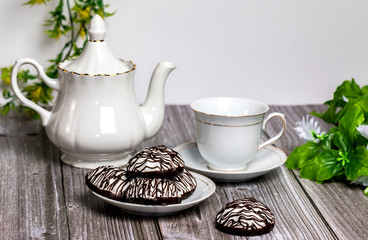 Marshmallows and tea set on a wooden table.
