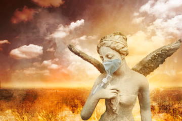 Angel statue using washing hand with Alcohol Sanitizer and dust mask on arid meadow background. To...