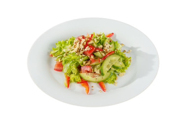 Caesar salad with pieces of chicken breast, tomato, bell pepper, cucumber, lettuce, walnuts on plate, white isolated background Side view. For the menu, restaurant, bar, cafe