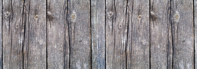 Natural wooden background. Vintage wooden texture. Old wooden boards with a knots close-up. Panoramic banner.