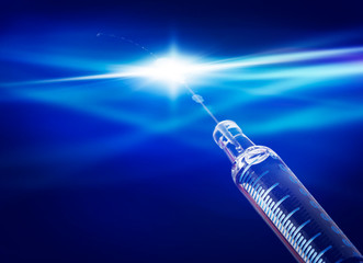 Syringe with serum, vaccination against a blue background