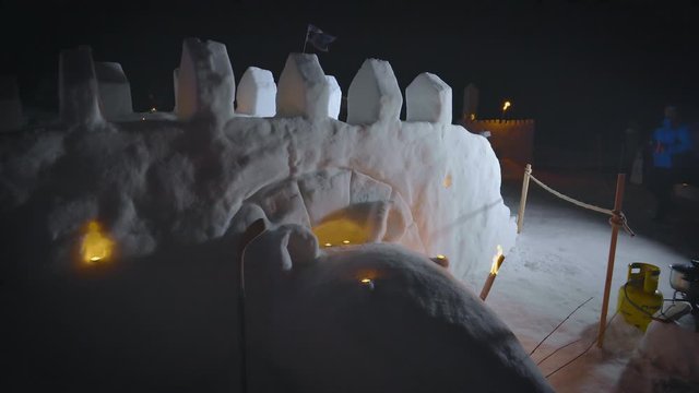 A castle ice sculpture display in the dark.