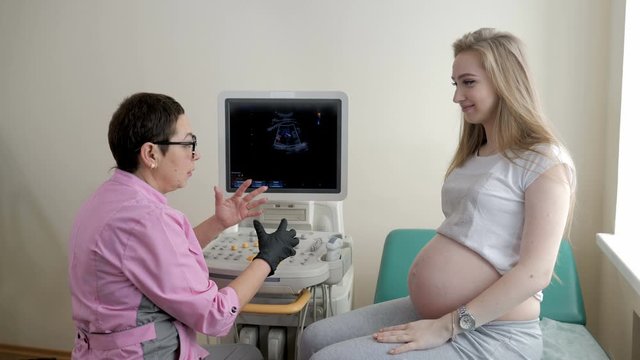 Young pregnant girl on the consultation before the ultrasound