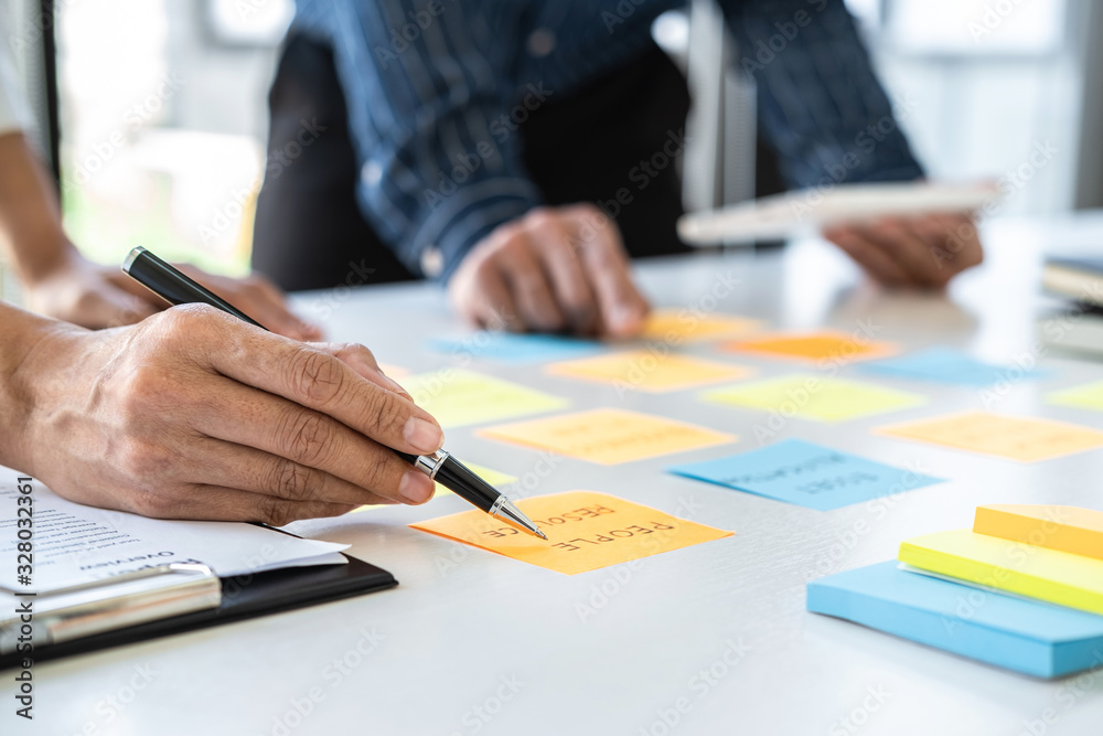 Aufkleber Two creative business people meeting and planning use post it notes sticky note on desk to share idea, Analysis data chart and graph with teamwork strategy brainstorming in office