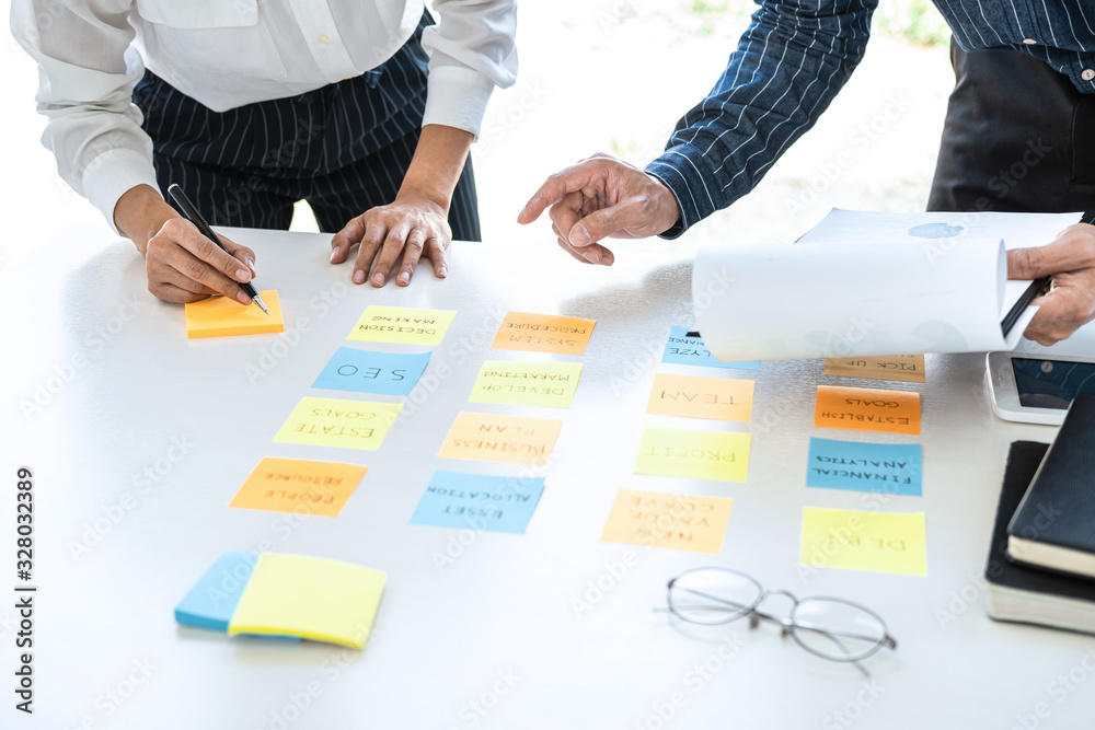 Aufkleber Two creative business people meeting and planning use post it notes sticky note on desk to share idea, Analysis data chart and graph with teamwork strategy brainstorming in office