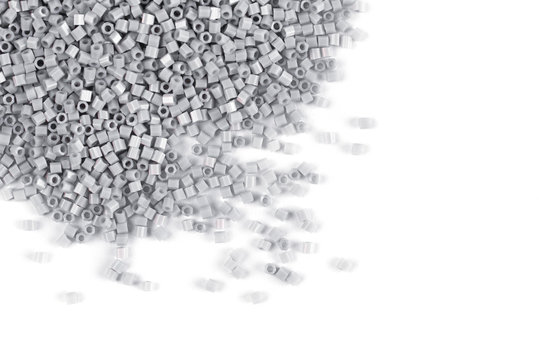 A Scattering Of Gray Matte Beads On A White Background