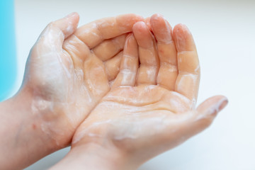 Child washing his hands to prevent illness