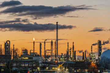 chemical plant against an orange evening sky