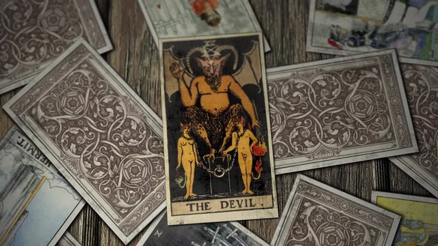 Making Prophecies on Tarot Cards. The Devil is in the Middle of a Deck, Meaning Bad for a Person and Self-Doubt. Close Up