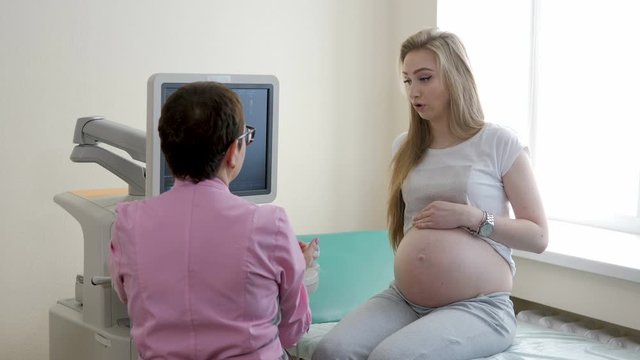 Young pregnant girl on the consultation before the ultrasound