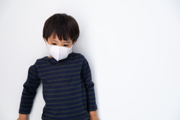 Air pollution pm2.5, virus and covid 19 protection concept. Little Asian boy with health mask protect virus on white background