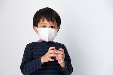 Air pollution pm2.5, virus and covid 19 protection concept. Little Asian boy with health mask protect virus on white background