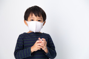 Air pollution pm2.5, virus and covid 19 protection concept. Little Asian boy with health mask protect virus on white background