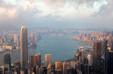 Cityscape Hong Kong on wide harbor banks against hills