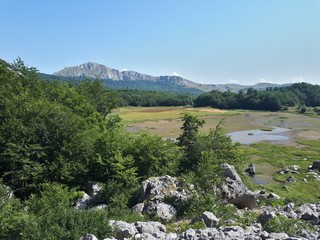 Fototapeta na wymiar Lake in the mountains and mountain panorama