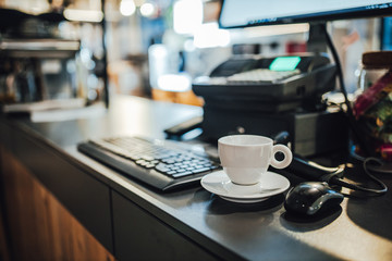 Obraz na płótnie Canvas White coffee cup by the shop counter