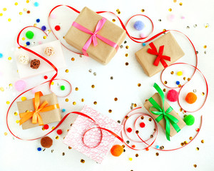 Gifts on a white background. Gift boxes, confetti, sparkles, satin ribbons on a white background. There is space for text. Holidays and celebrations.