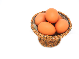 A group of eggs stacked in wicker baskets isolated on a white background. The concept of a high protein and vitamin diet can be eaten every day.