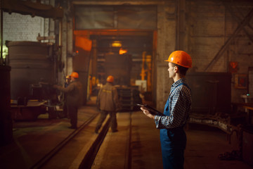Master looks on steelmaking process in furnace