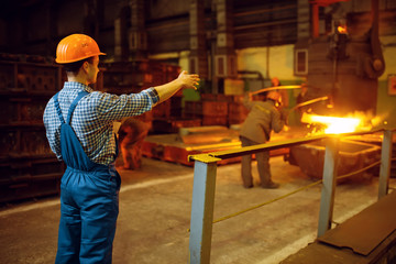 Master looks on steelmaking process in furnace