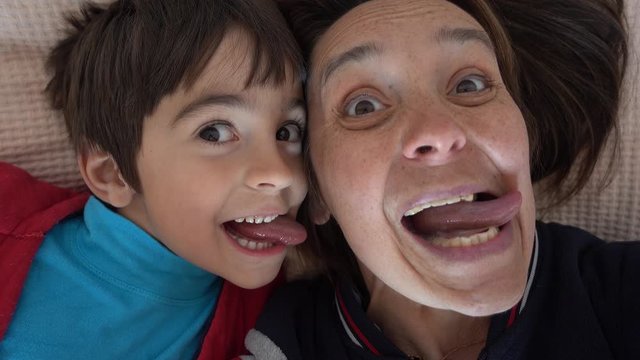 4K Selfie of Funny mother and son putting out their tongues