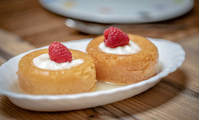 French dessert Baba Au Rum over a wooden table