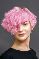 Portrait of woman with pink hairstyle.
