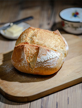 Traditional French Boule bread over a wooden table