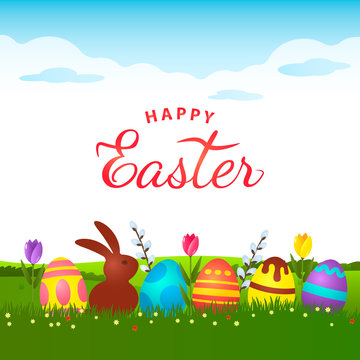 Invitation or greeting card with greeting text Happy Easter. A cute chocolate bunny rabbit is sitting on the green grass with