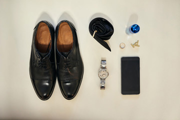 different accessories of a businessman for creating a style of a people lie on a wooden background