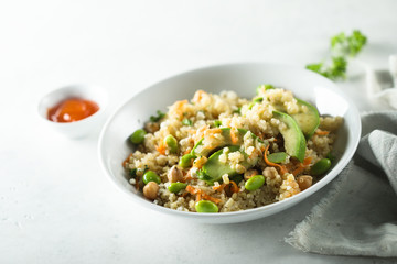 Healthy quinoa bowl with soy beans and avocado
